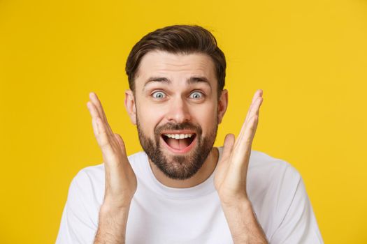 Young casual man portrait isolated on yellow background.