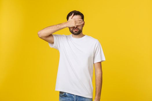 Young caucasian handsome man isolated on beige background covering eyes by hands. Do not want to see something