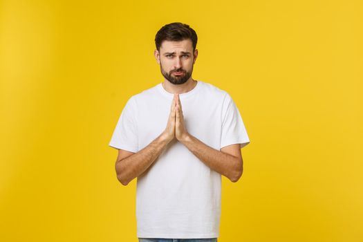 Calm and handsome. Portrait of handsome young man keeping hands clasped and looking thoughtful