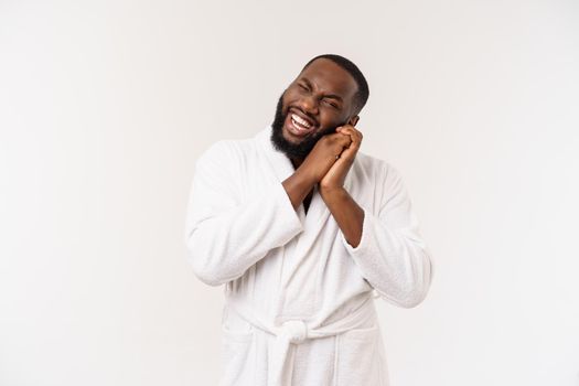 African American man wearing a bathrobe with surprise and happy emotion. Isolated over whtie background.