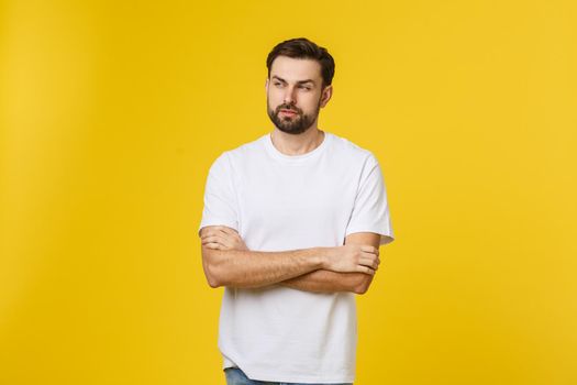 Portrait of a handsome young man smiling against yellow background.