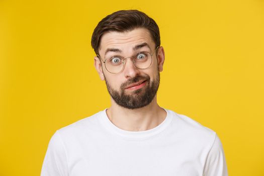 Young casual man portrait isolated on yellow background.