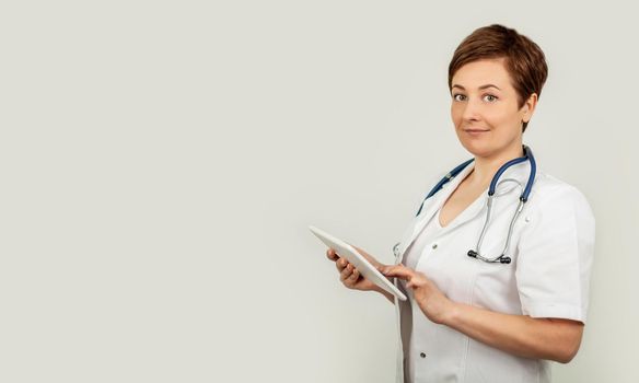 Portrait of a female doctor using her digital tablet. Female doctor using tablet and checking with analysis on a virtual interface. Medicine. Medical science and biotechnology.
