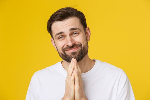 Young casual man portrait isolated on yellow background.