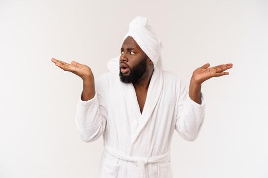 Black guy wearing a bathrobe pointing finger with surprise and happy emotion. Isolated over whtie background