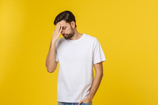 Pensive curious man looking up in thinking pose trying to make choice or decision isolated on yellow background