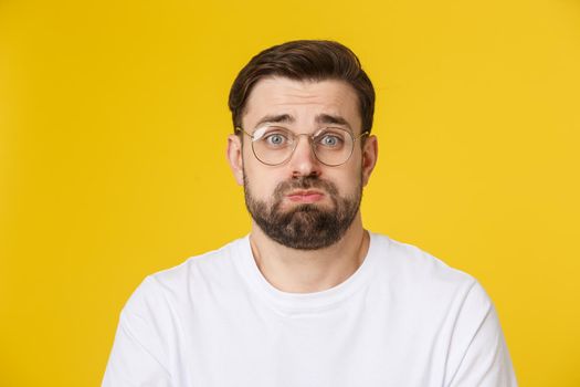 Young casual man portrait isolated on yellow background.