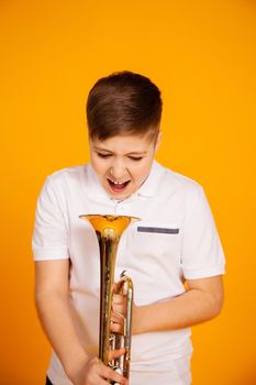 The boy screams into the pipe. Annoyed displeased boy shows his anger