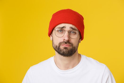 Adult hispanic man over isolated background depressed and worry for distress, angry and afraid. Sad expression.