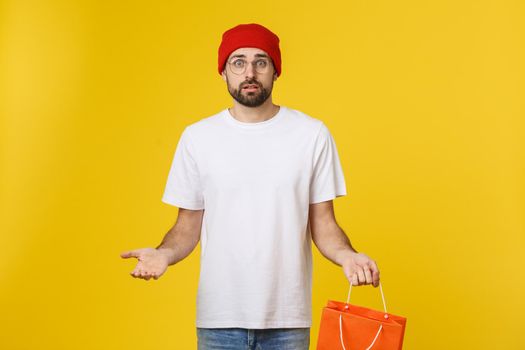 Handsome man with shopping bag feeling worry and serious