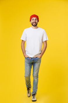 young hipster man wearing hat , suspenders, isolate on yellow background