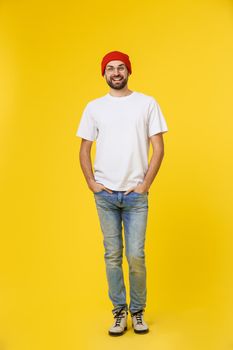 young hipster man wearing hat , suspenders, isolate on yellow background