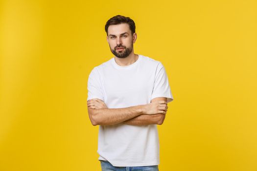 Portrait of a handsome young man smiling against yellow background.