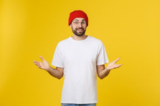 Portrait unhappy handsome man looking at camera on yellow background