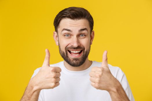 Portrait of caucasian man with big beard in white shirt. Bearded man shows thumbs up.