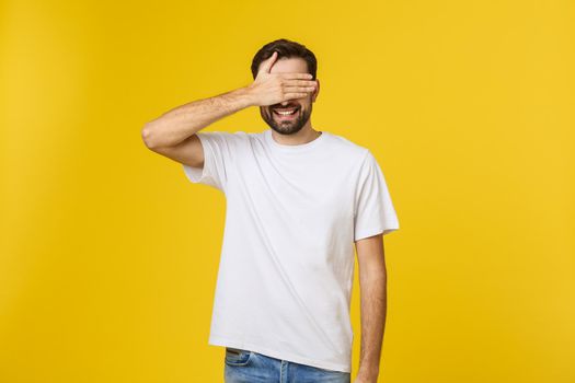 Young caucasian handsome man isolated on beige background covering eyes by hands. Do not want to see something