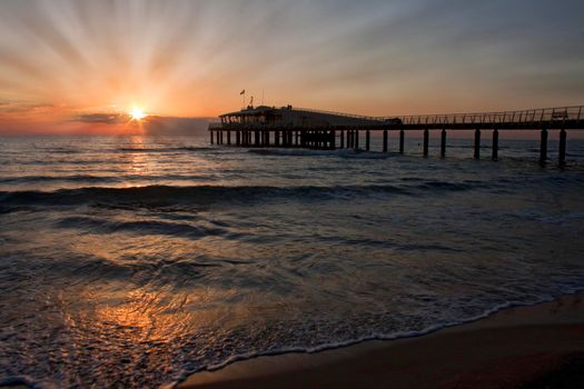 Lido di Camaiore peer and beach, Tuscany, Italy at sunset