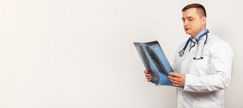 A male doctor looks and studies an x-ray of the chest. A snapshot of a person s lungs with signs of pneumonia. A genetic snapshot of small cell lung cancer
