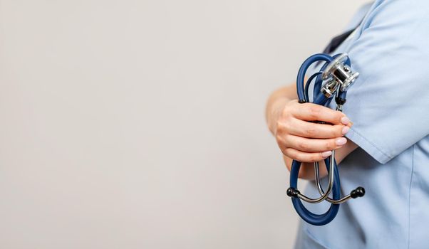 Healthcare and medical concept. A doctor with a stethoscope in his hand. Female doctor pediatrician holding a stethoscope in hand