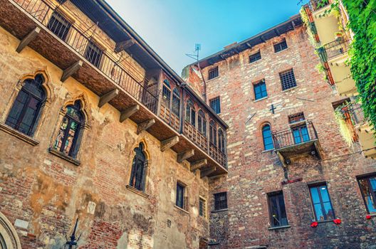 Casa di Giulietta with windows and brick wall of building, Juliet Capulet house courtyard in Verona city historical centre Citta Antica, vintage retro style photo, Veneto Region, Northern Italy