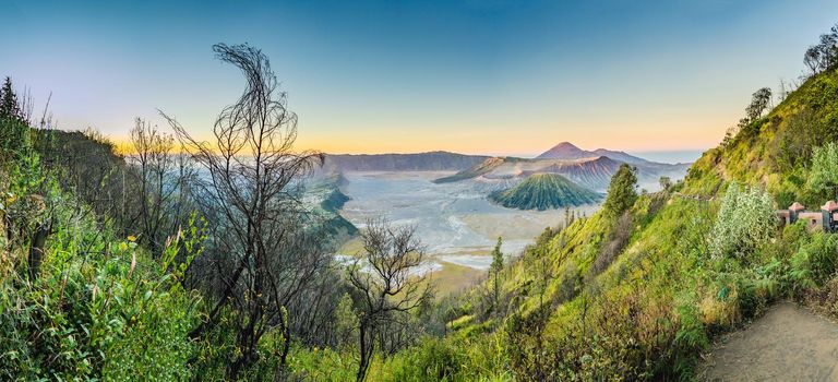 Sunrise at the Bromo Tengger Semeru National Park on the Java Island, Indonesia. View on the Bromo or Gunung Bromo on Indonesian, Semeru and other volcanoes located inside of the Sea of Sand within the Tengger Caldera. One of the most famous volcanic objects in the world. Travel to Indonesia concept.