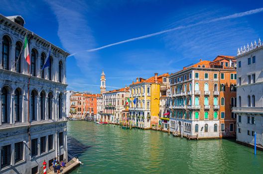 Grand Canal waterway in Venice historical city centre with Palazzo Civran palace, Venetian colorful buildings and Church of the Holy Apostles of Christ bell tower. Veneto Region, Northern Italy.