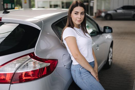 Woman in Ukraine waiting to get fuel at the gas station. Fuel shortage in Ukraine.