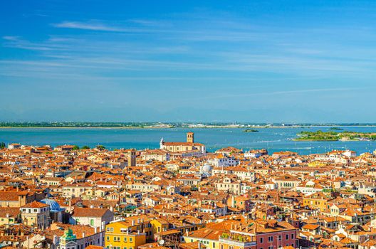 Aerial panoramic view of Venice city old historical centre, buildings with red tiled roofs, Marco Polo airport background, Veneto Region, Northern Italy. Amazing Venice cityscape.