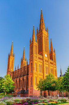 Evangelical Market Protestant church Wiesbaden or Marktkirche neo-Gothic style building on Schlossplatz Palace Square in historical city centre, blue sky background, State of Hesse, Germany