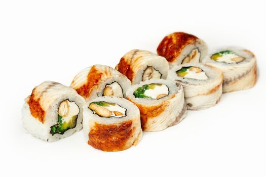 Sushi roll with eel and chuka salad on a white plate, classic Japanese sushi. Traditional Japanese food with maki. Delicious pieces of sushi. For the restaurant menu. copyspace.