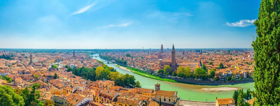 Panorama of Verona historical city centre, bridges across Adige river, Basilica di Santa Anastasia, medieval buildings with red tiled roofs, Veneto Region, Italy. Panoramic view of Verona cityscape