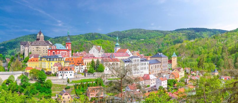 Aerial panoramic view of medieval Loket town with Loket Castle Hrad Loket gothic style on massive rock, colorful buildings. Panorama of Loket town and green hills, Karlovy Vary Region, Czech Republic