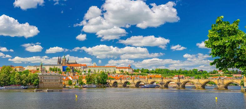 Panorama of Prague city historical centre with Prague Castle, St. Vitus Cathedral in Hradcany district, Charles Bridge Karluv Most across Vltava river. Panoramic view of Prague city, Czech Republic