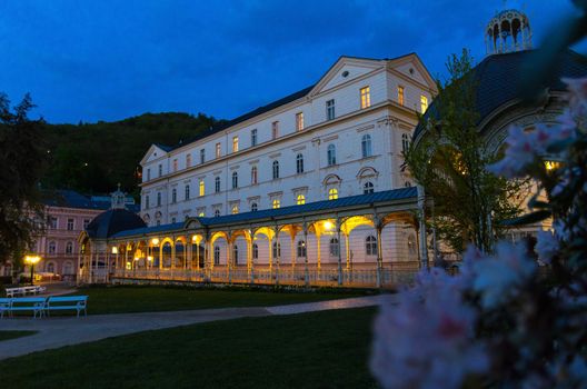 Park Colonnade with wooden arbor and lights in Dvorak Park Dvorakovy sady in Karlovy Vary Carlsbad historical city centre, evening twilight view, West Bohemia, Czech Republic