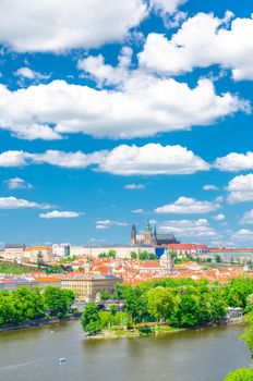 Aerial vertical view of Prague city, historical center with Prague Castle, St. Vitus Cathedral in Hradcany district, Strelecky island, Vltava river, blue sky white clouds, Bohemia, Czech Republic