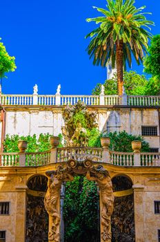 Balustrade with green plants and palm tree of Palazzo Doria Tursi palace classic style building on Via Garibaldi street in historical centre of old european city Genoa Genova, Liguria, Italy