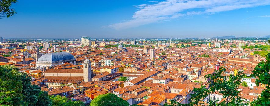 Aerial panoramic view of old historical city centre of Brescia city with churches, towers and medieval buildings with red tiled roofs, Lombardy, Northern Italy. Panorama of Brescia town.