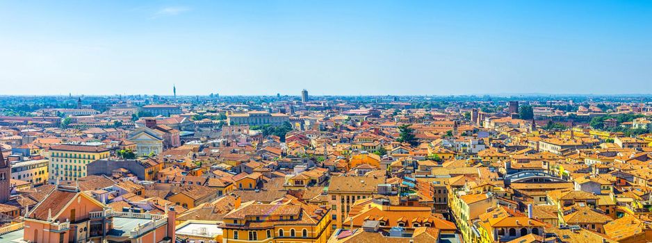 Aerial panoramic view of Verona city historical centre Citta Antica with red tiled roof buildings. Panorama of Verona town cityscape. Blue sky background copy space. Veneto Region, Northern Italy