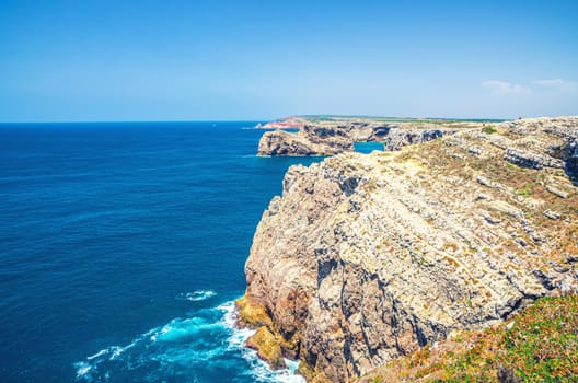 Rocks and cliffs of Atlantic Ocean near Cape Saint Vincent Cabo de Sao Vicente southwesternmost point of mainland Europe, Pedra das Gaivotas island, Portuguese coastline, Algarve district, Portugal