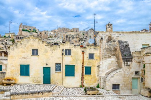 Stone building in Sassi di Matera town historical centre Sasso Caveoso, ancient town with rock cave houses, blue sky and white clouds, UNESCO World Heritage, Basilicata, Southern Italy