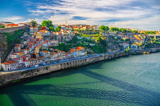 Aerial panoramic view of Porto Oporto city with colorful buildings and traditional houses on steep slope and embankment of Douro River, Norte or Northern Portugal