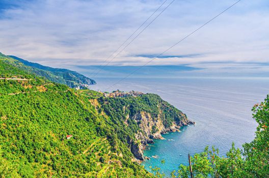 Aerial panoramic view of Corniglia typical Italian village with colorful buildings on rock cliff, Genoa Gulf of Ligurian Sea, National park Cinque Terre, La Spezia, Liguria, Italy