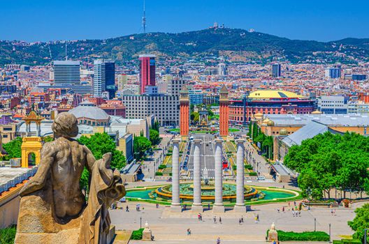 Cityscape of Barcelona with aerial view of Placa d'Espanya or Spain square with Torres Venecianes Venetian towers, Montju c fountain and Four Columns Les Quatre Columnes, Tibidabo hill background