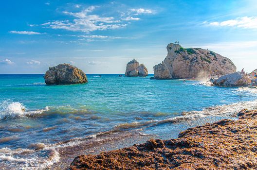 Aphrodite Beach with Stone Rocks in Aphrodite bay of Mediterranean sea water, blue sky in sunny day background, Petra tu Romiou, Cyprus