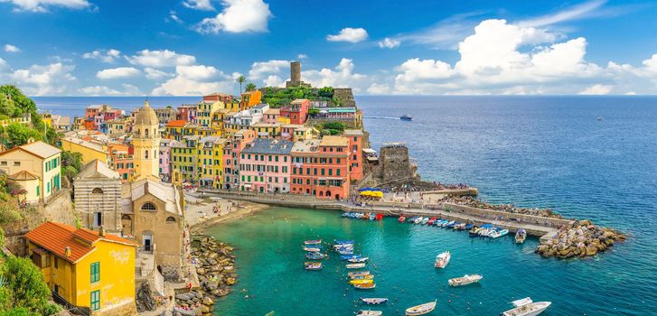 Vernazza village with typical colorful multicolored buildings houses, Castello Doria castle on rock and marina harbor with boats, Ligurian Sea, National park Cinque Terre, La Spezia, Liguria, Italy