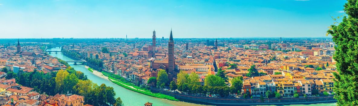 Panorama of Verona historical city centre, bridges across Adige river, Basilica di Santa Anastasia, medieval buildings with red tiled roofs, Veneto Region, Italy. Panoramic view of Verona cityscape