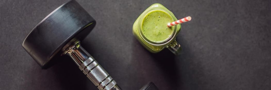 Green smoothies and dumbbells in the gym. BANNER, LONG FORMAT