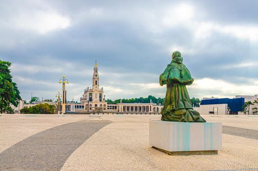 Sanctuary of Our Lady of Fatima with Basilica of Our Lady of the Rosary catholic church with colonnade, Estatua do Papa Sao Paulo VI statue monument and street lantern lamp in Fatima town, Portugal