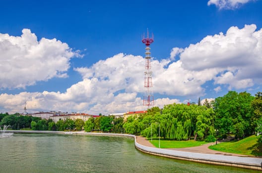 Minsk cityscape with Svislach or Svislac river embankment and television tower in historical centre, blue sky white clouds in sunny summer day, Republic of Belarus