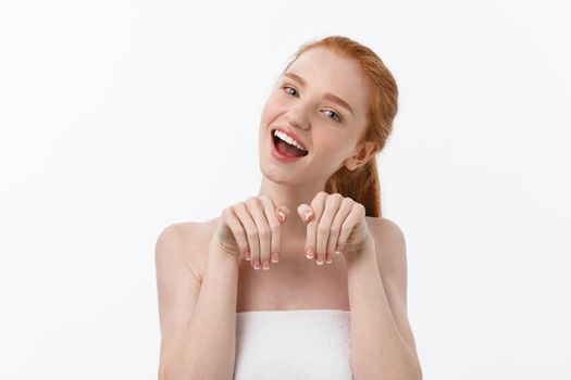 Beauty portrait of a smiling young woman with looking at camera isolated over gray background.